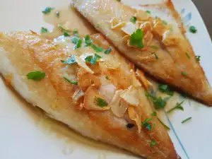 Dorade mit Knoblauch in der Pfanne